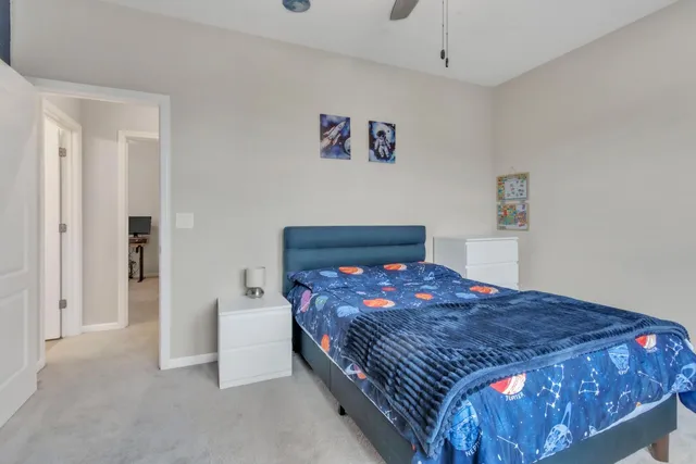 a bedroom with a bed and a painting on the wall