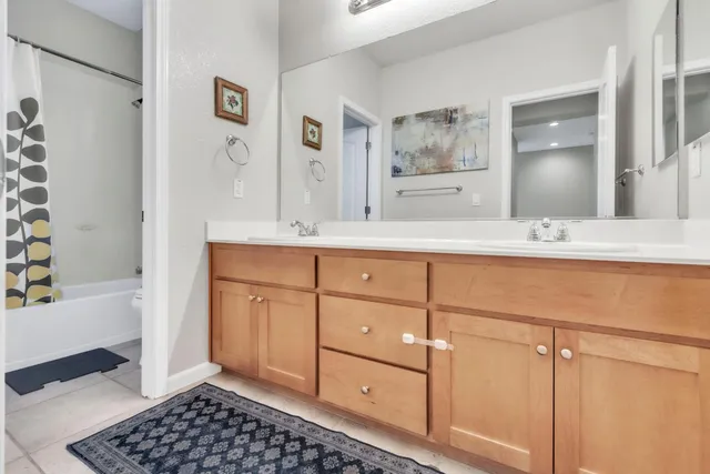 a bathroom with a bathtub sink vanity and mirror