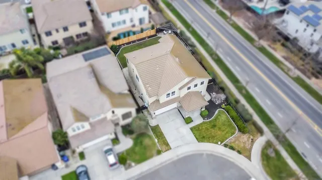 an aerial view of a house a swimming pool and outdoor seating