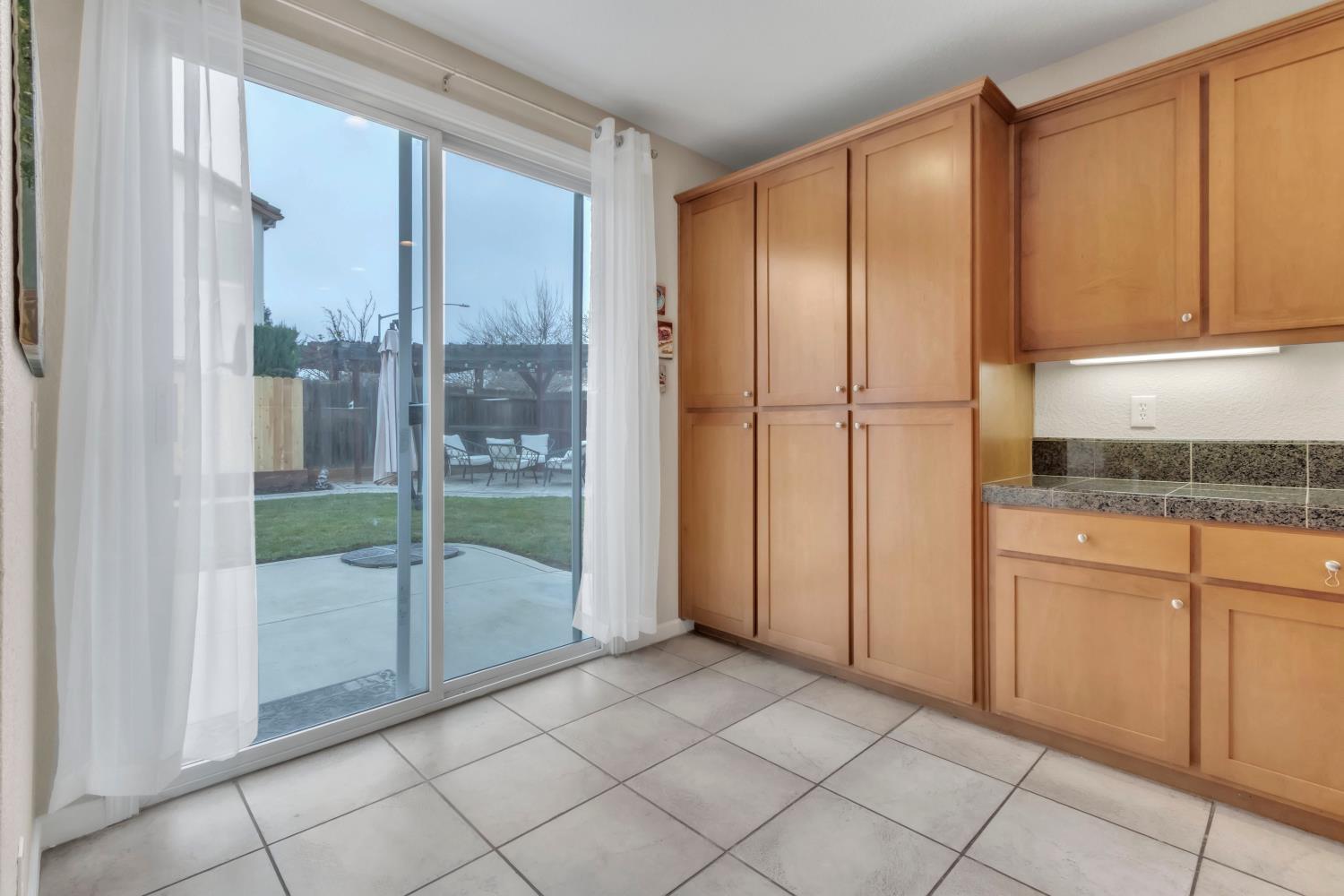 2993 Essie Place Modesto, CA 95355 - Photo 9 of 44 a view of a glass door with a kitchen