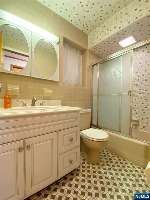 133 Oak Street, Unit 1 Weehawken, NJ 07086 - Photo 4 of 9 a bathroom with a sink a toilet and shower