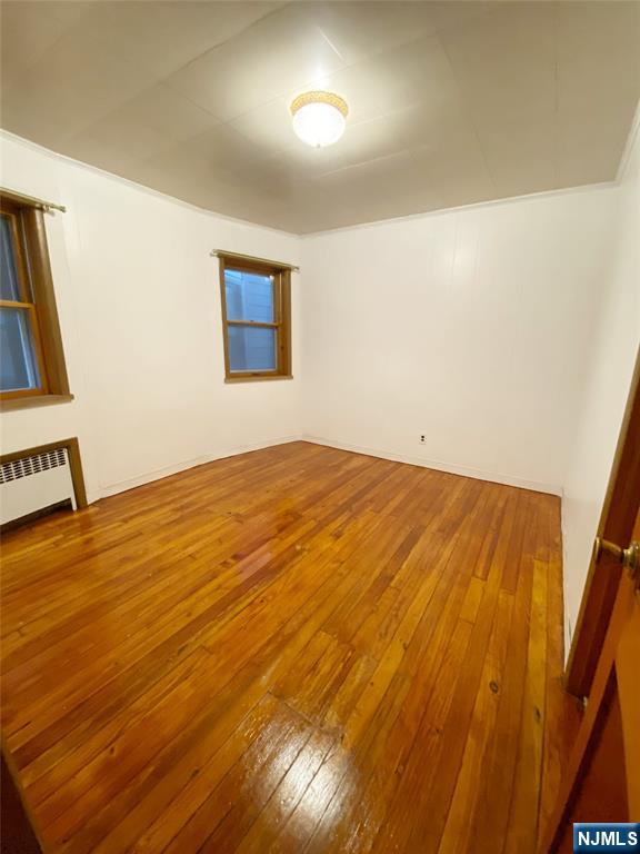 133 Oak Street, Unit 1 Weehawken, NJ 07086 - Photo 8 of 9 a view of empty room with wooden floor