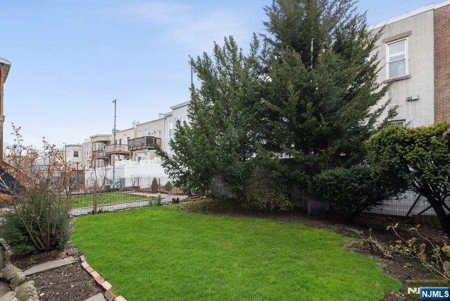 133 Oak Street, Unit 1 Weehawken, NJ 07086 - Photo 9 of 9 a view of a garden with a building in the background