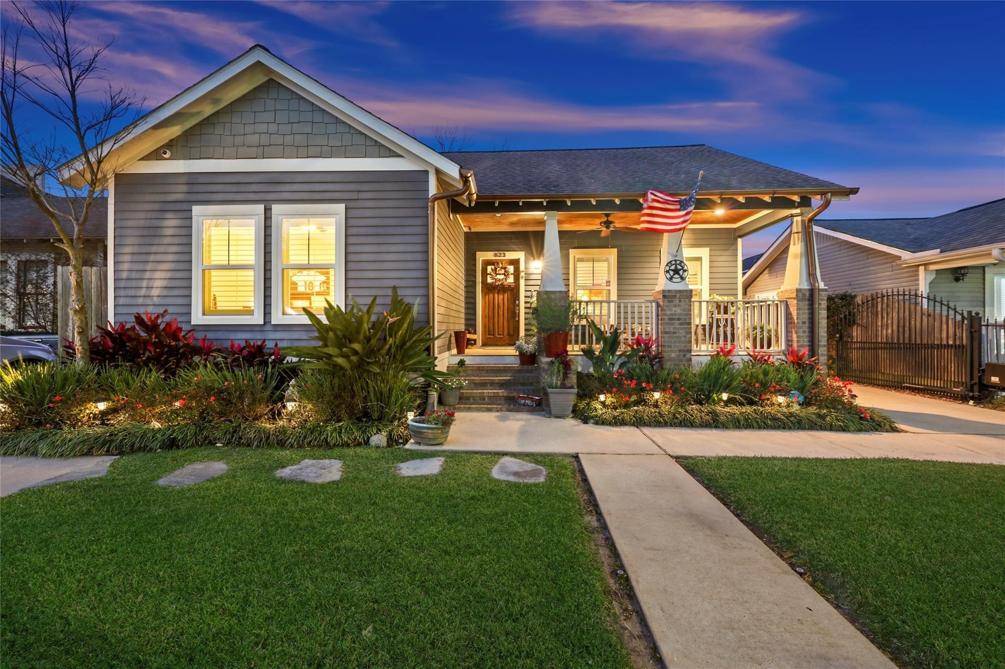 Highlighting the home's architecture, premium landscape lighting transforms the curb appeal at dusk.
