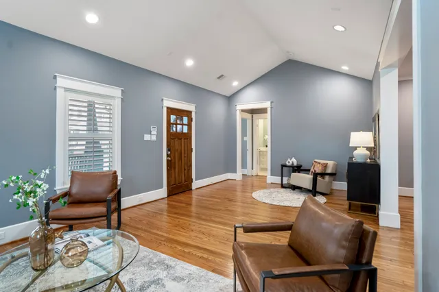 a living room with furniture and a potted plant