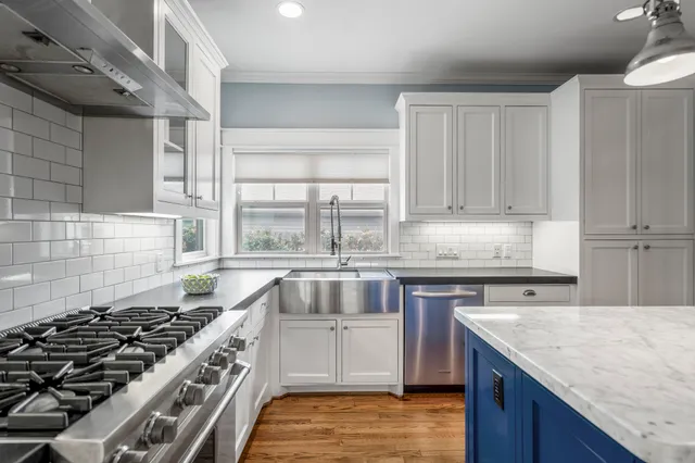 a kitchen with granite countertop a stove and a sink