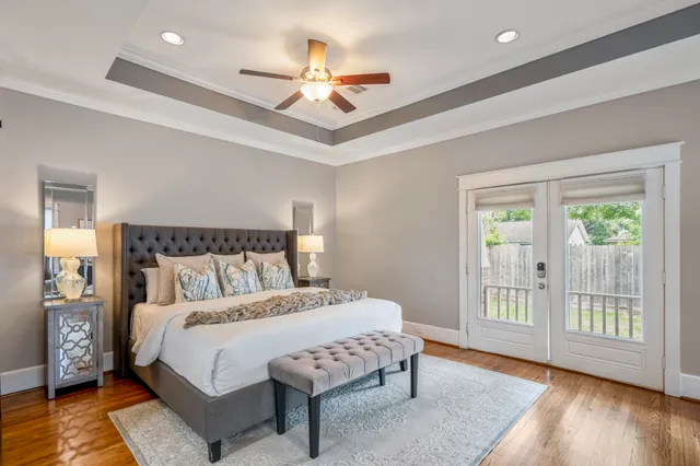 a bedroom with a large bed and a chandelier