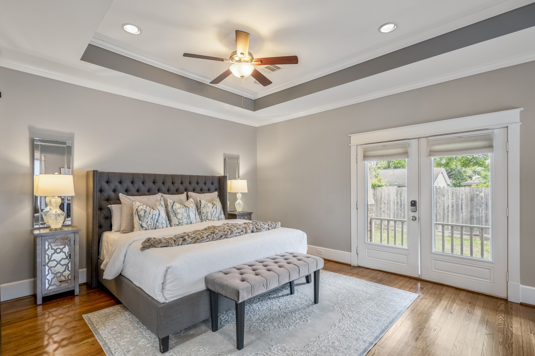 823 East 27th Street Houston, TX 77009 - Photo 21 of 49 a bedroom with a large bed and a chandelier