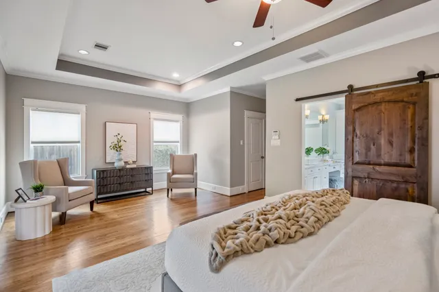 a bedroom with a bed window and couch