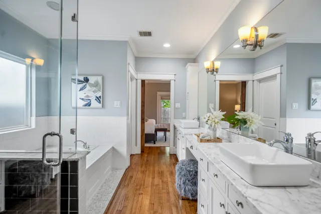 a spacious bathroom with a double vanity sink and a mirror