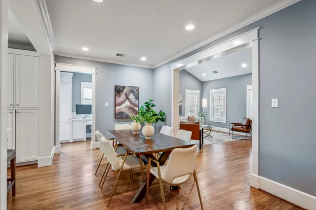 a dining room with furniture and wooden floor