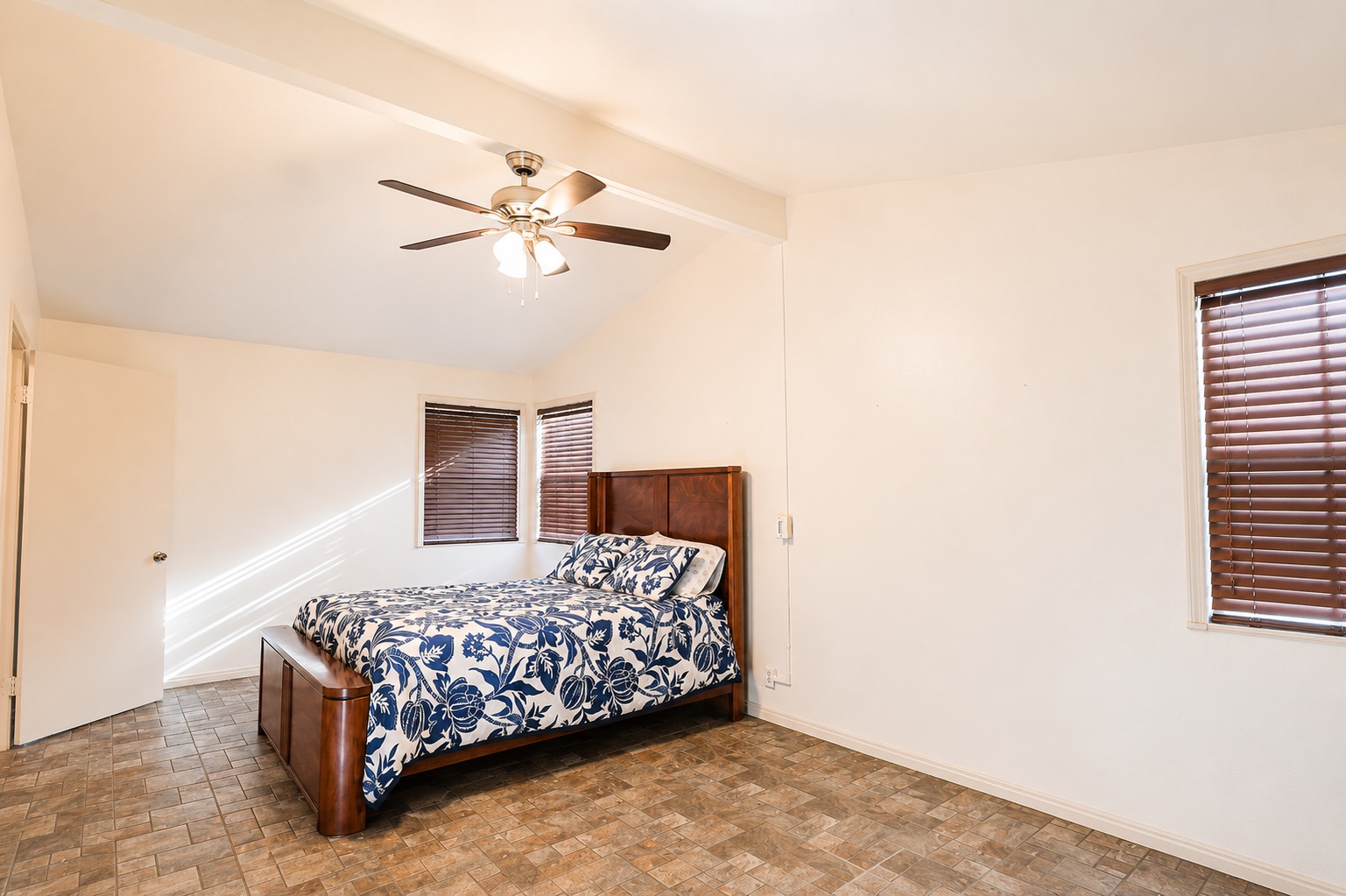 1508 Walnut Street Georgetown, TX 78626 - Photo 26 of 37 A well-lit bedroom features vaulted ceilings and practical tiled flooring for easy maintenance.
