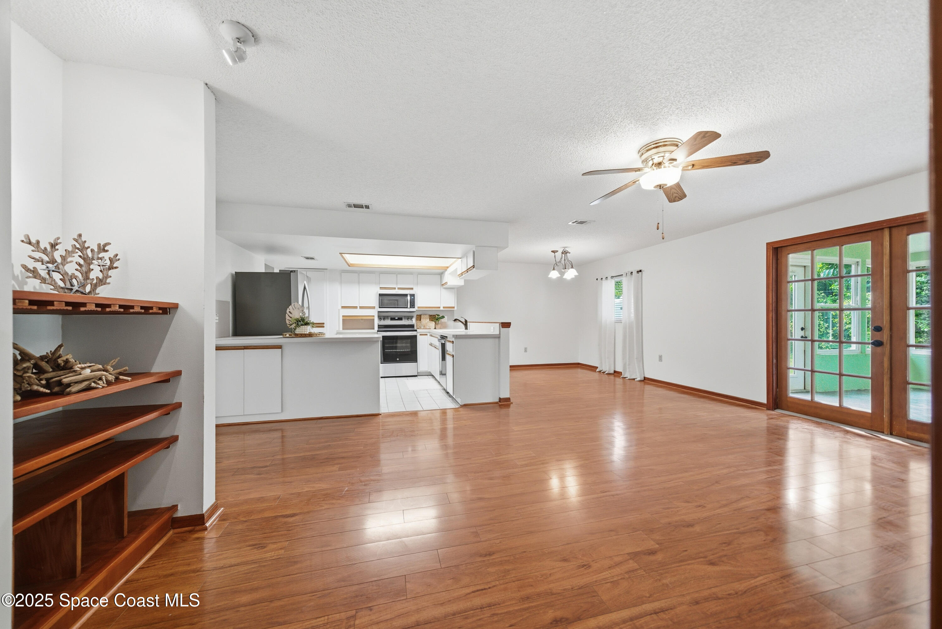 2108 Rosewood Drive Melbourne Beach, FL 32951 - Photo 11 of 39 a view of a kitchen with furniture appliances and wooden floor