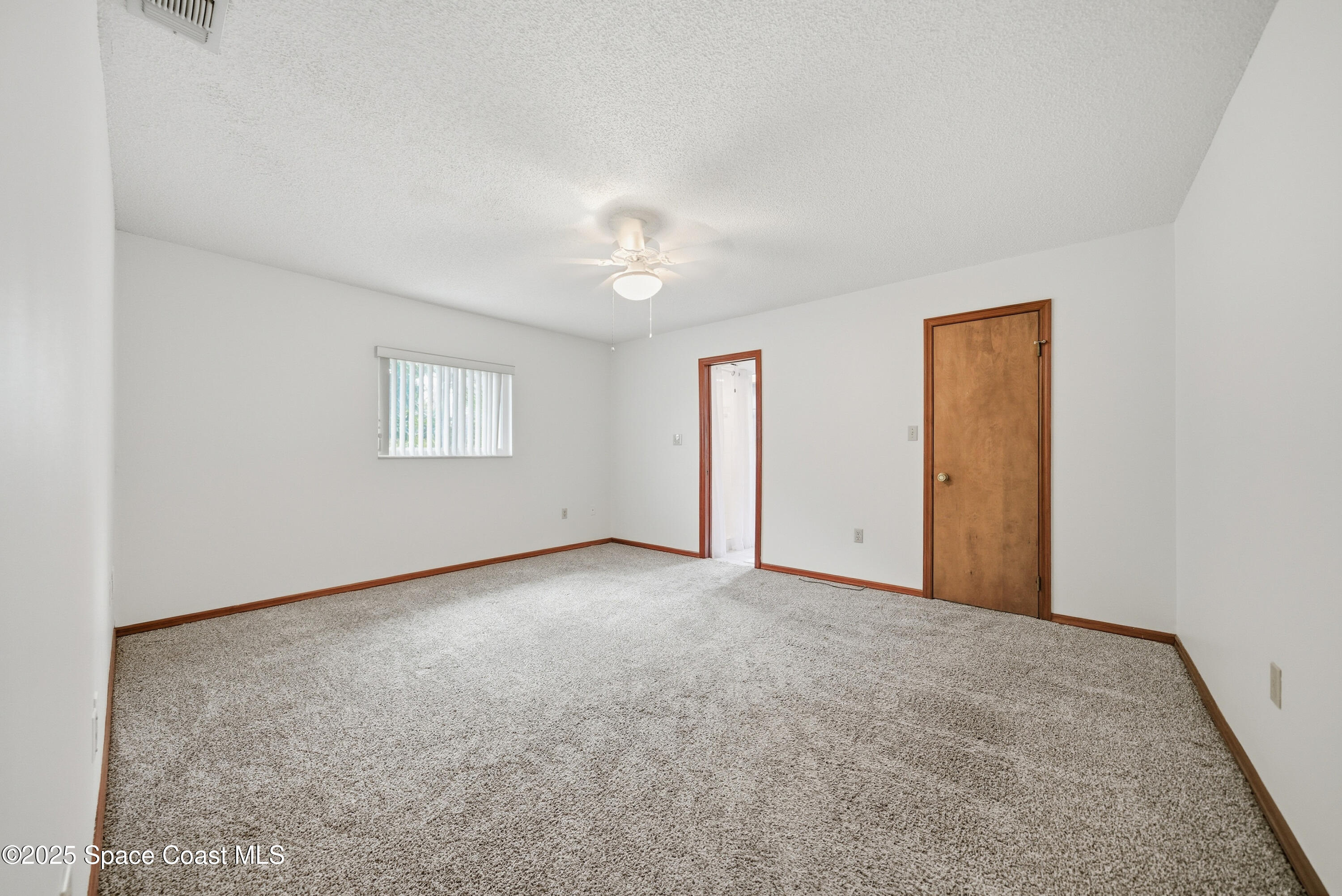 2108 Rosewood Drive Melbourne Beach, FL 32951 - Photo 13 of 39 an empty room with windows and closet