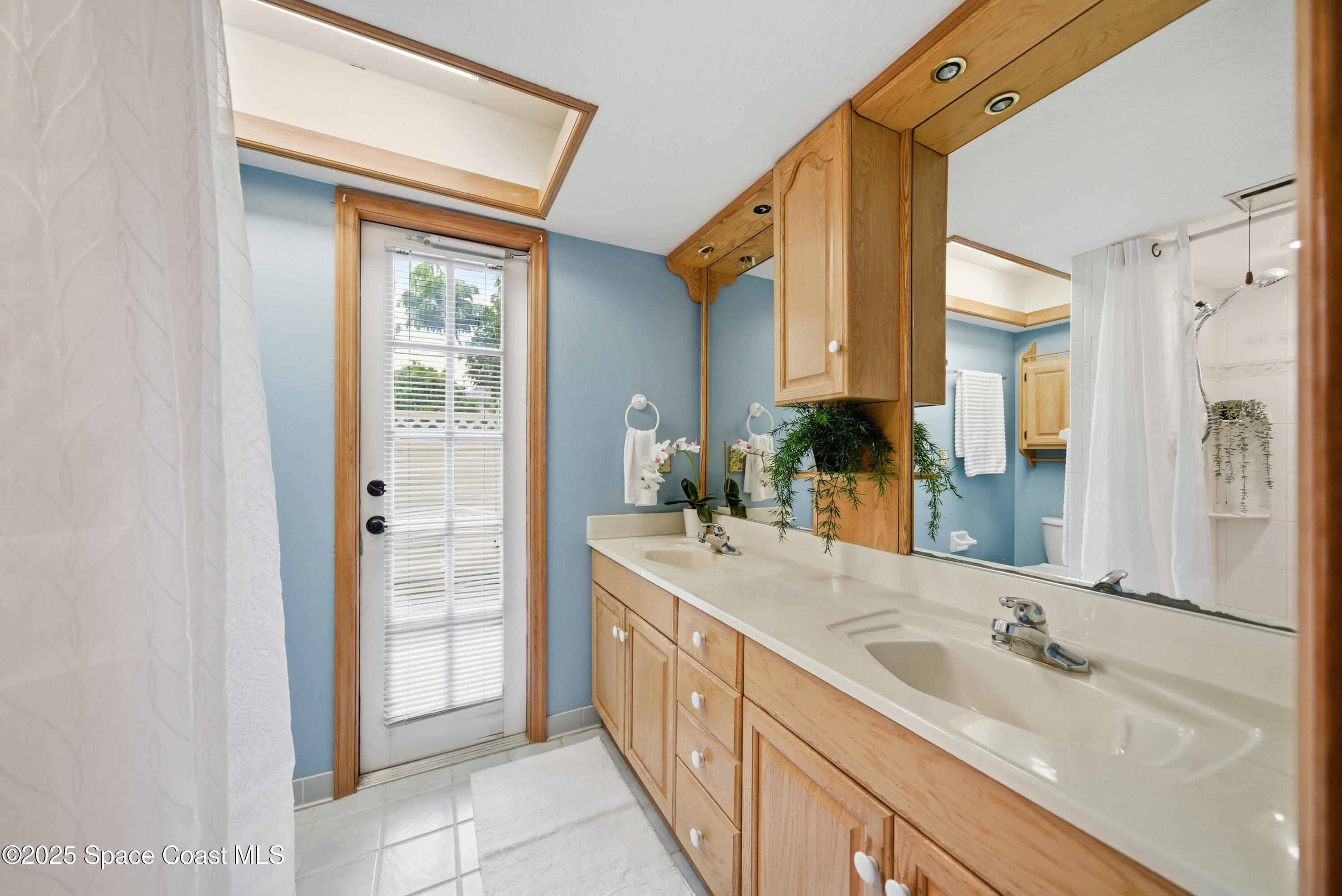 2108 Rosewood Drive Melbourne Beach, FL 32951 - Photo 14 of 39 a spacious bathroom with a double vanity sink a mirror and a shower