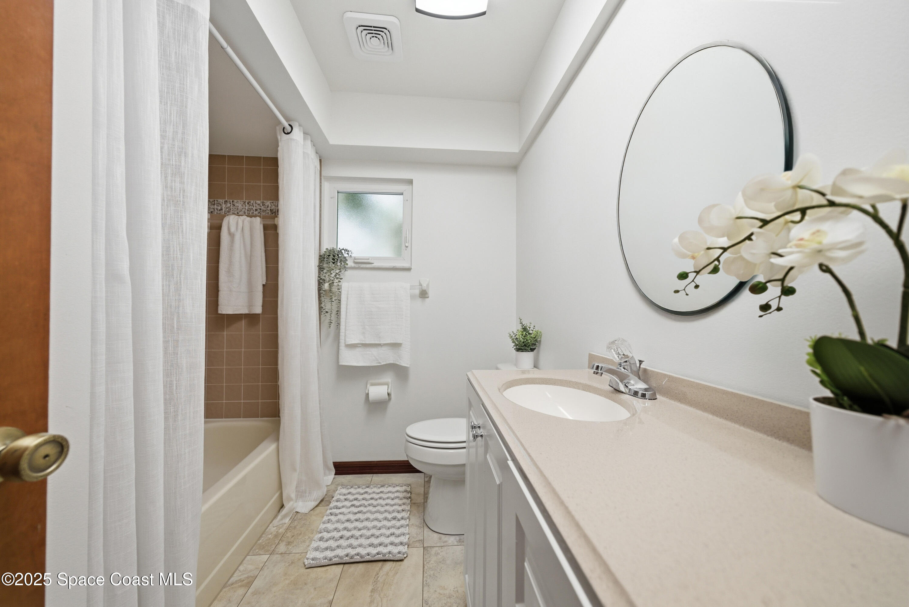 2108 Rosewood Drive Melbourne Beach, FL 32951 - Photo 18 of 39 a bathroom with a sink a toilet and a mirror