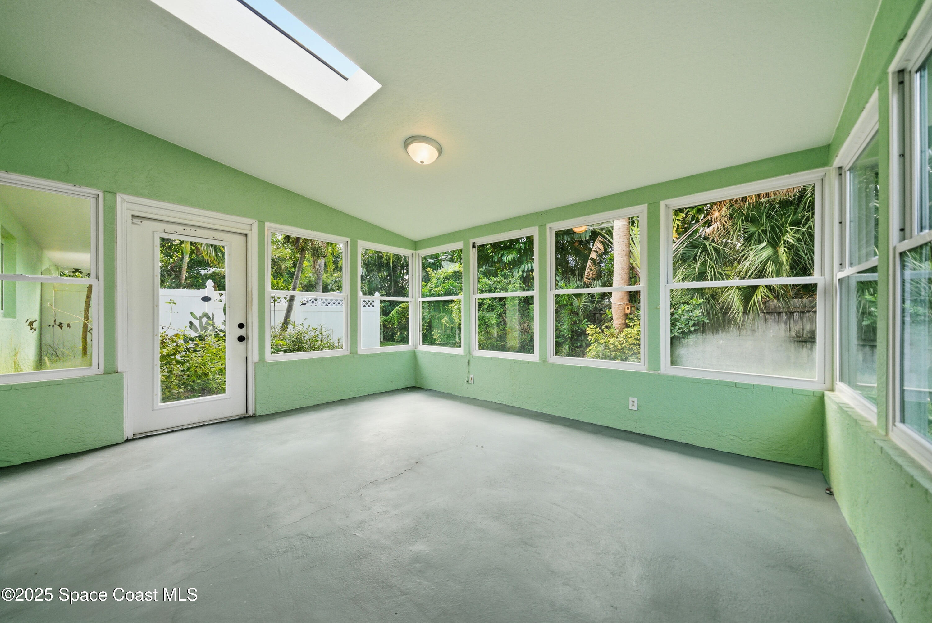 2108 Rosewood Drive Melbourne Beach, FL 32951 - Photo 22 of 39 a view of an empty room with large windows