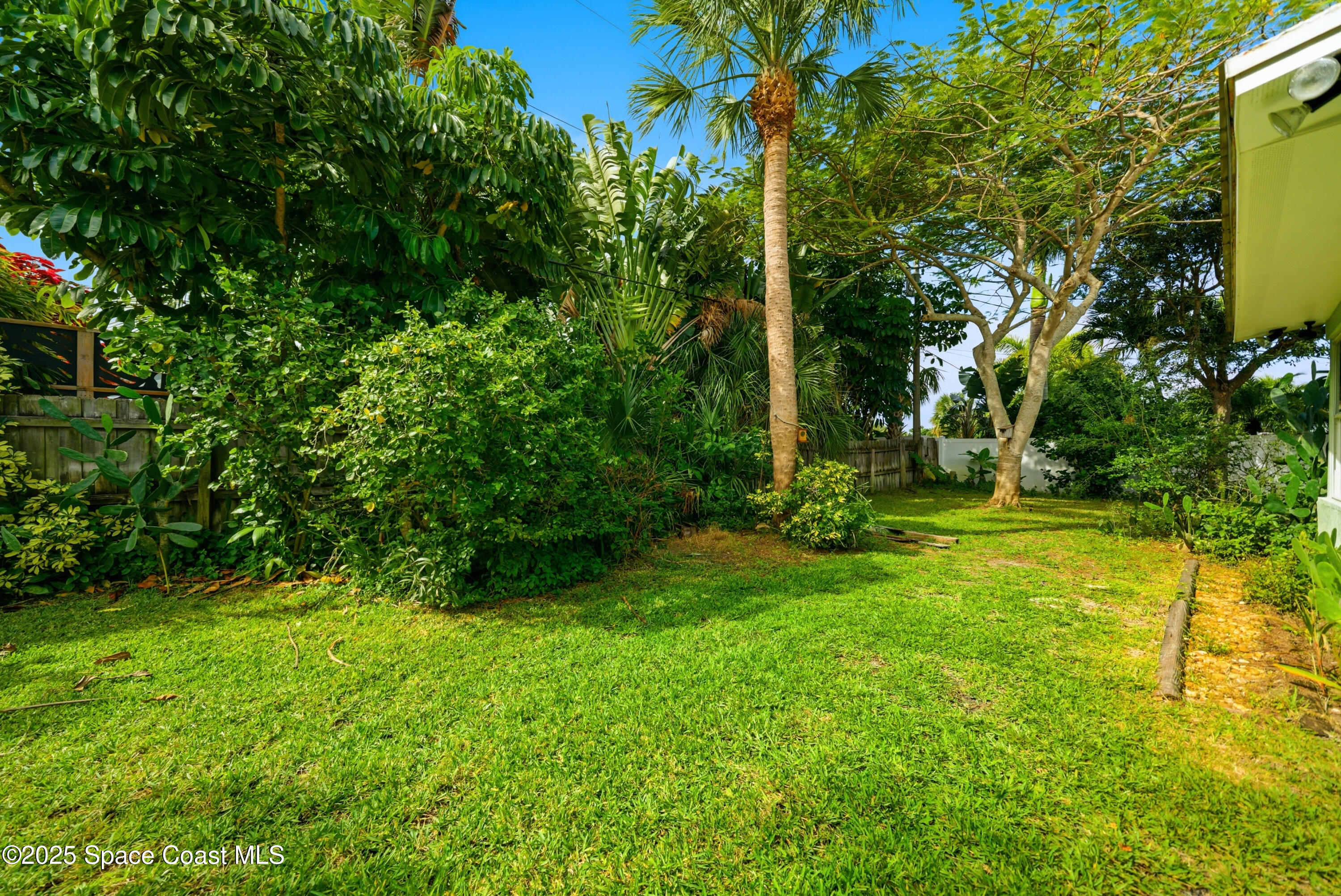 2108 Rosewood Drive Melbourne Beach, FL 32951 - Photo 29 of 39 a view of a yard with a tree