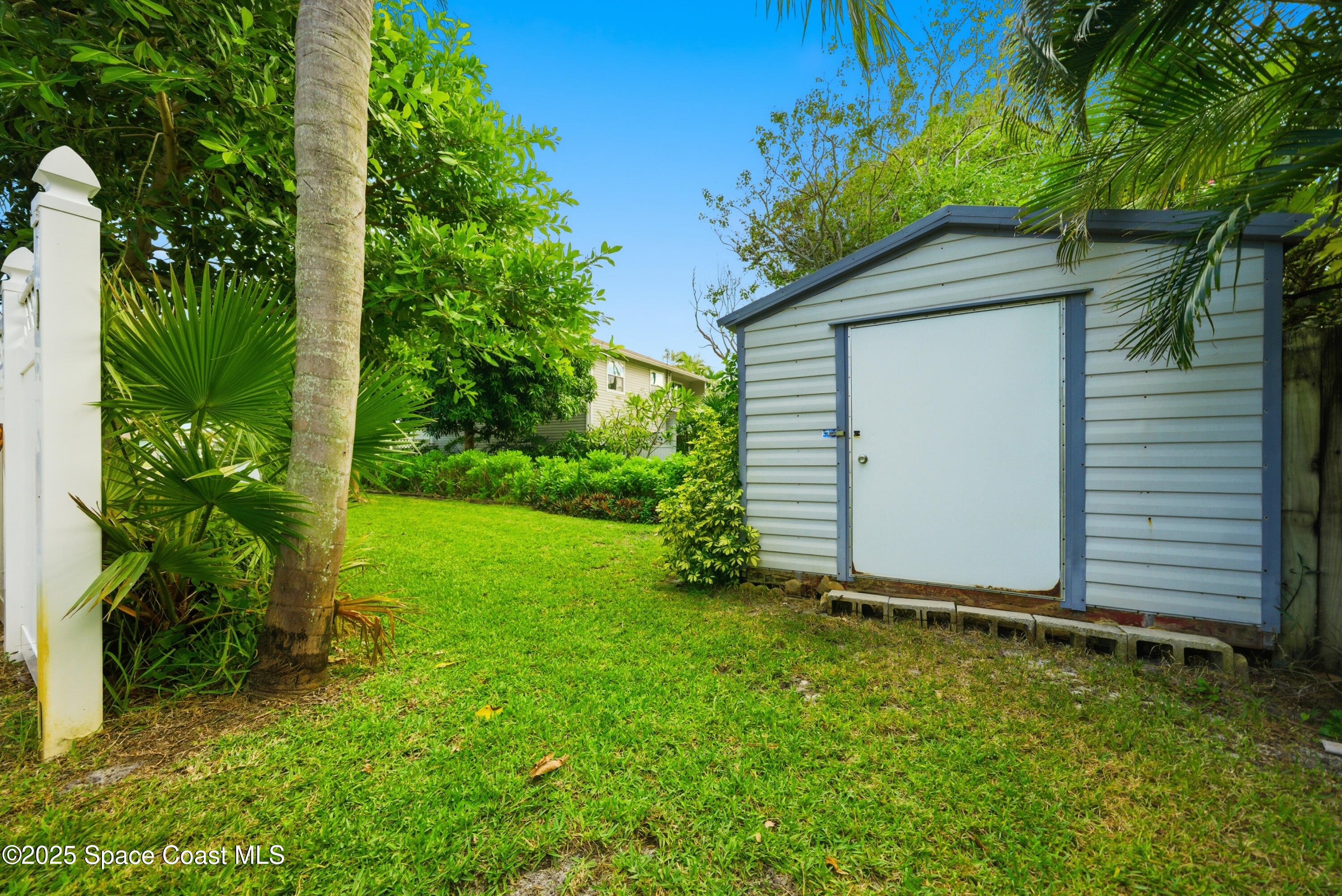 2108 Rosewood Drive Melbourne Beach, FL 32951 - Photo 32 of 39 a house with a tree in front of it