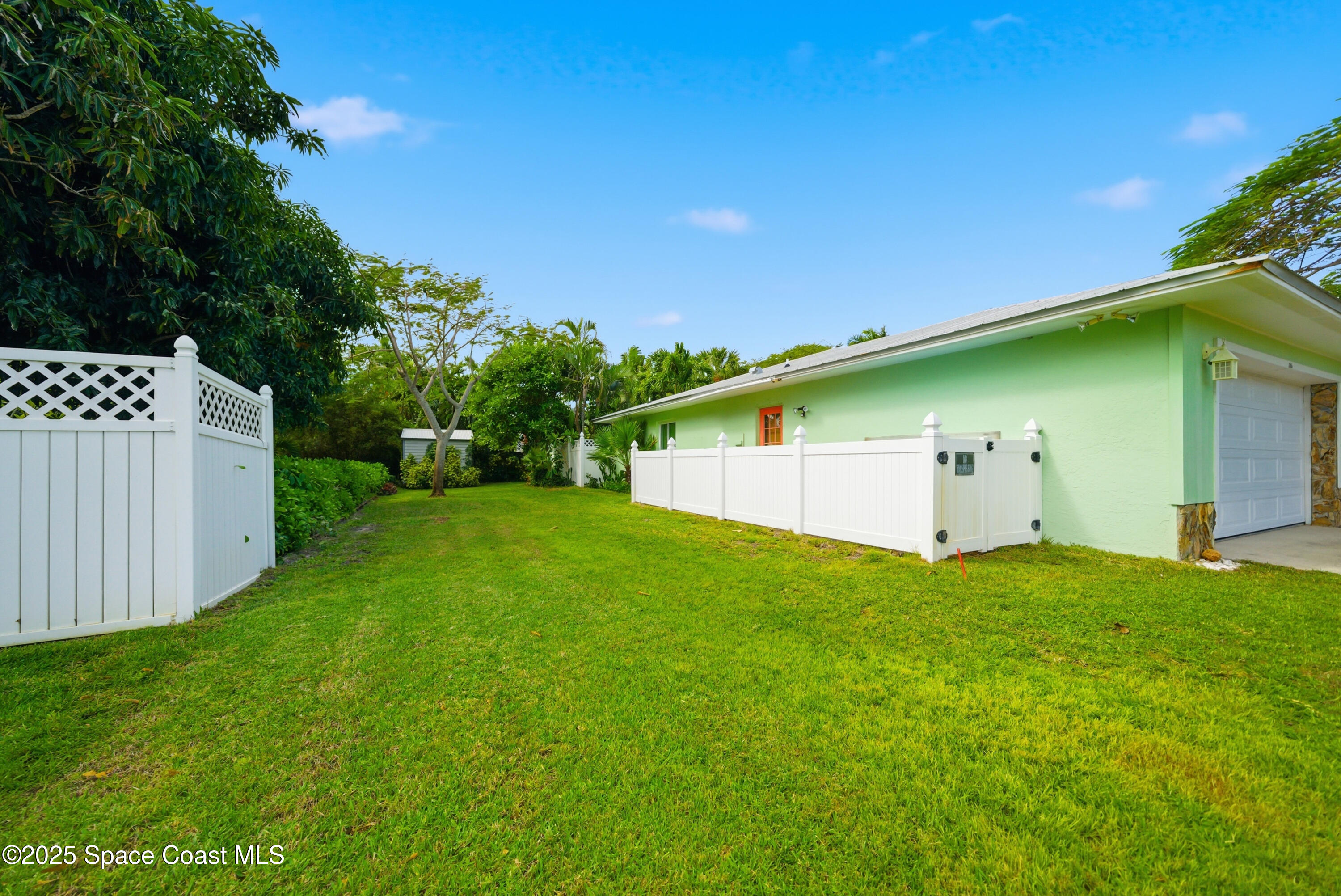 2108 Rosewood Drive Melbourne Beach, FL 32951 - Photo 33 of 39 a view of a backyard with a garden and entertaining space