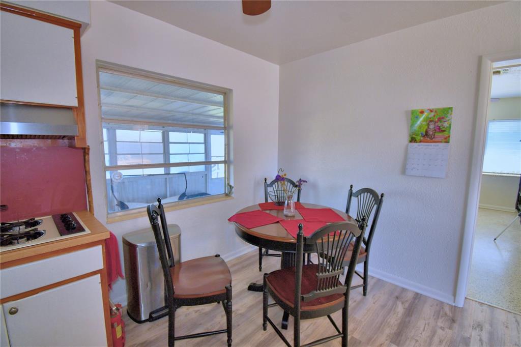 105 Maxcy Lane Frostproof, FL 33843 - Photo 11 of 49 a view of a dining room with furniture and wooden floor