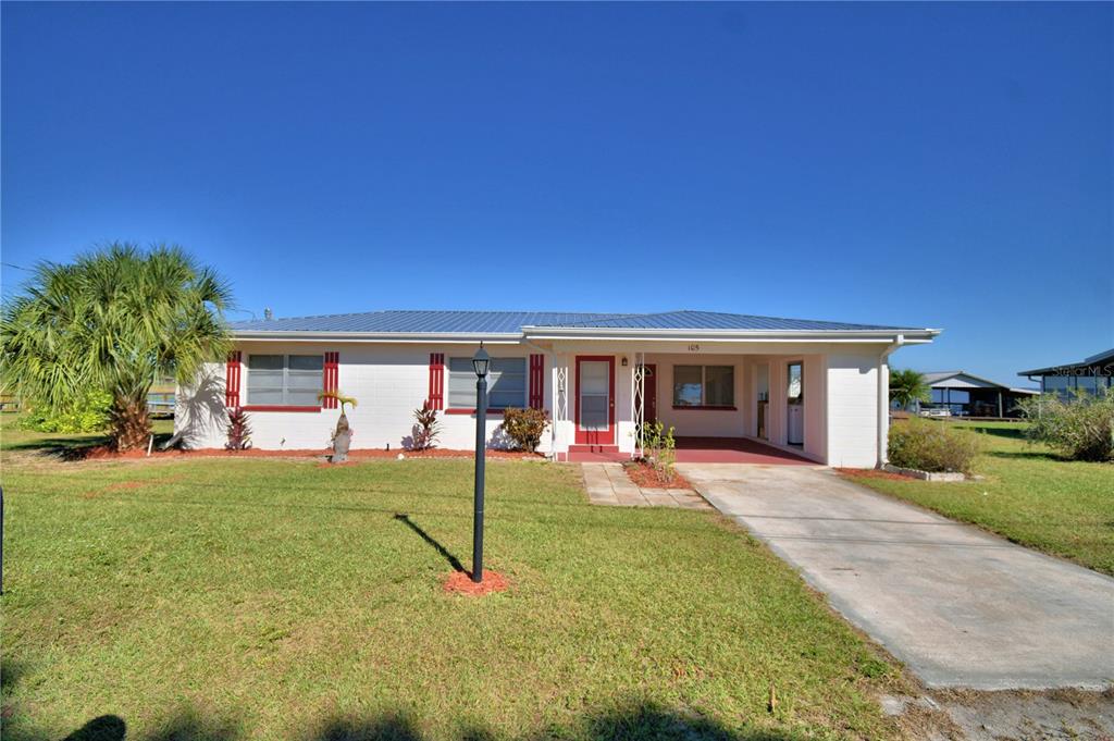 105 Maxcy Lane Frostproof, FL 33843 - Photo 12 of 49 a house view with a sitting space and garden