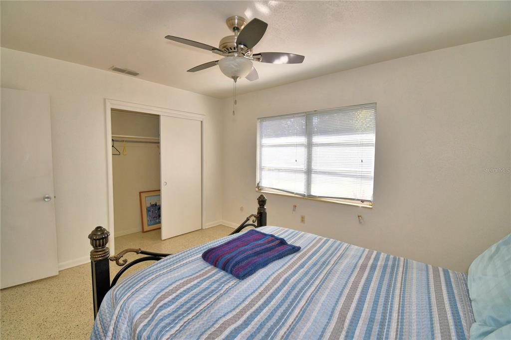 105 Maxcy Lane Frostproof, FL 33843 - Photo 14 of 49 a bedroom with a large bed and a chandelier