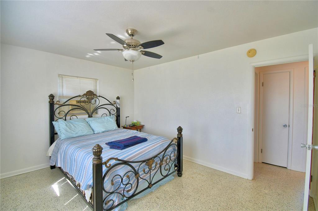 105 Maxcy Lane Frostproof, FL 33843 - Photo 15 of 49 a bedroom with a bed and a ceiling fan