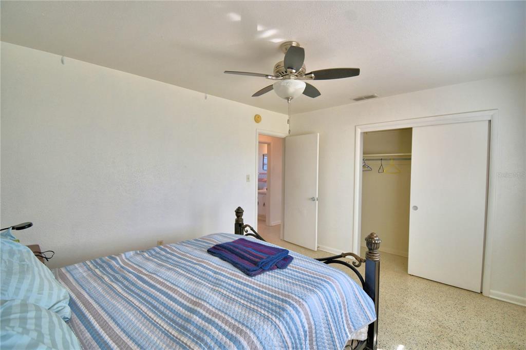 105 Maxcy Lane Frostproof, FL 33843 - Photo 16 of 49 a bedroom with a bed and a chandelier