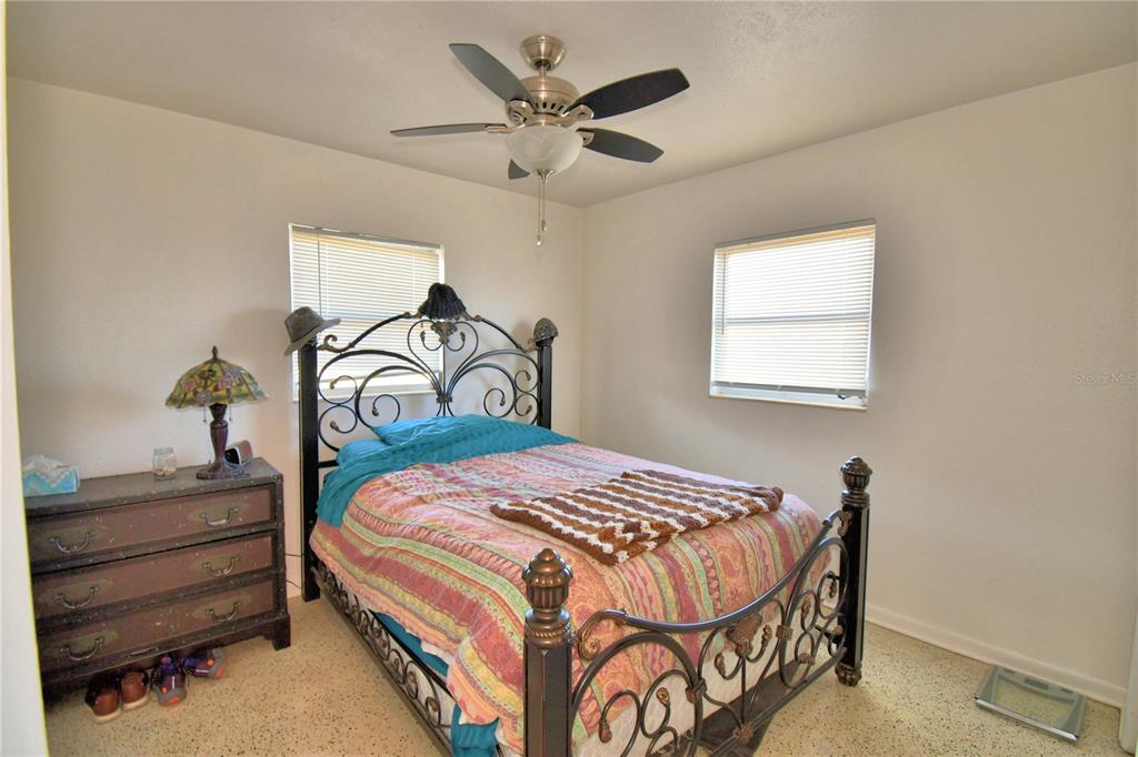 105 Maxcy Lane Frostproof, FL 33843 - Photo 21 of 49 a bedroom with a bed and a chandelier