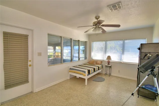 a bedroom with furniture and windows