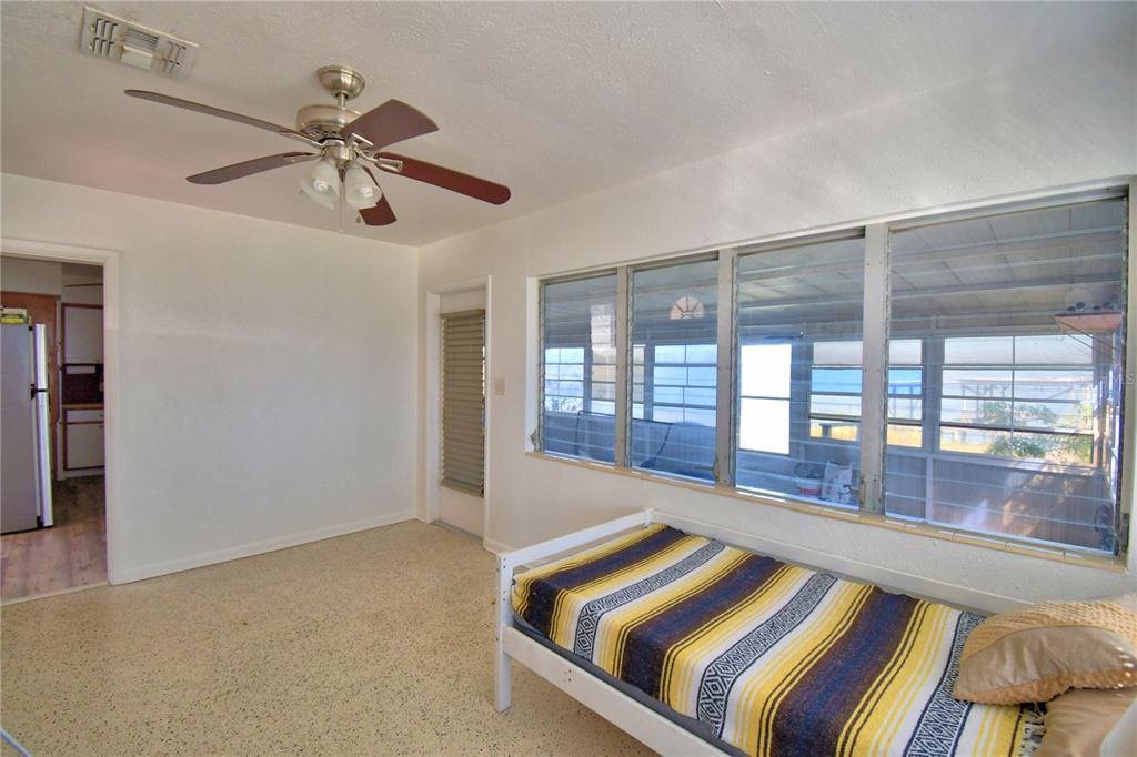 105 Maxcy Lane Frostproof, FL 33843 - Photo 27 of 49 a room with a balcony a bed and a chandelier