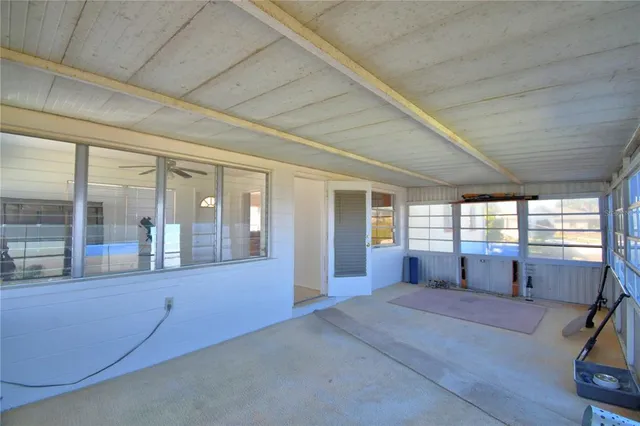 a spacious bedroom with a large bed and large windows