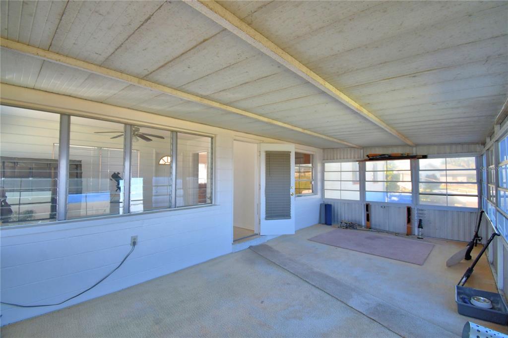 105 Maxcy Lane Frostproof, FL 33843 - Photo 31 of 49 a spacious bedroom with a large bed and large windows