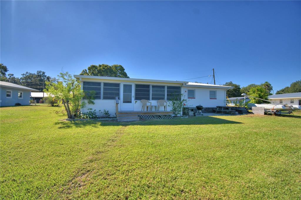 105 Maxcy Lane Frostproof, FL 33843 - Photo 32 of 49 a view of a house with a swimming pool