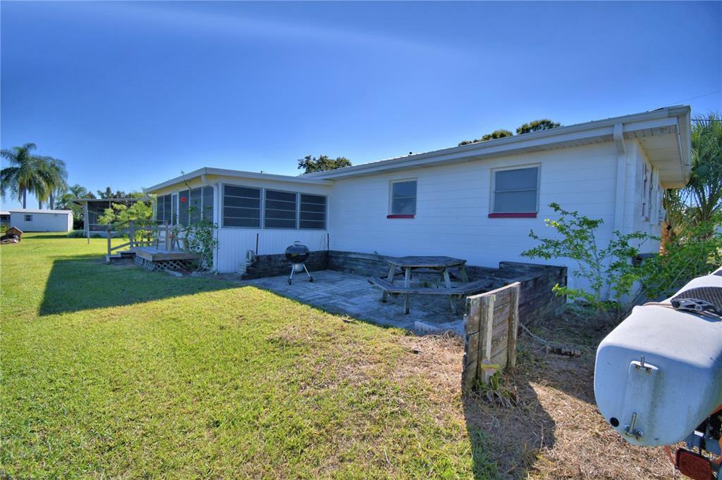 105 Maxcy Lane Frostproof, FL 33843 - Photo 35 of 49 a view of a house with backyard and sitting area