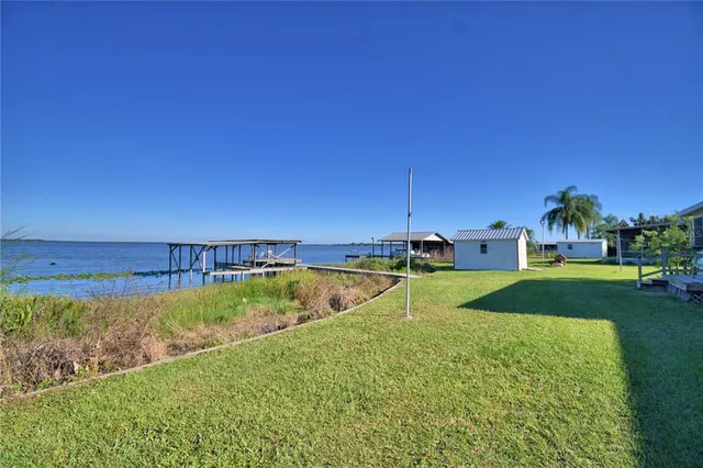 a view of a house with swimming pool and yard