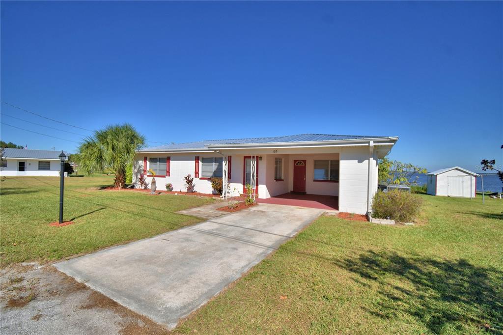 105 Maxcy Lane Frostproof, FL 33843 - Photo 40 of 49 a front view of a house with a yard