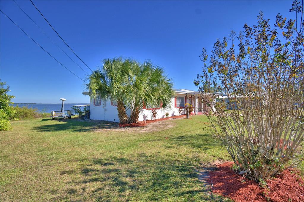 105 Maxcy Lane Frostproof, FL 33843 - Photo 43 of 49 a view of a big yard with a house