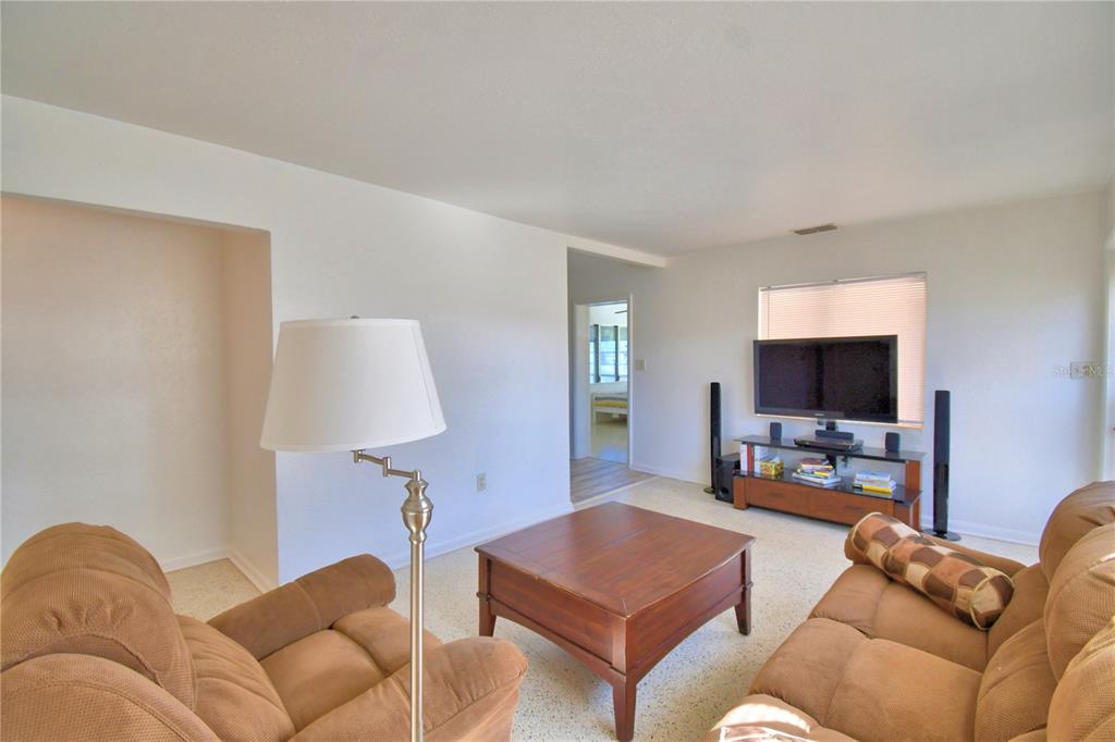 105 Maxcy Lane Frostproof, FL 33843 - Photo 6 of 49 a living room with furniture and a flat screen tv
