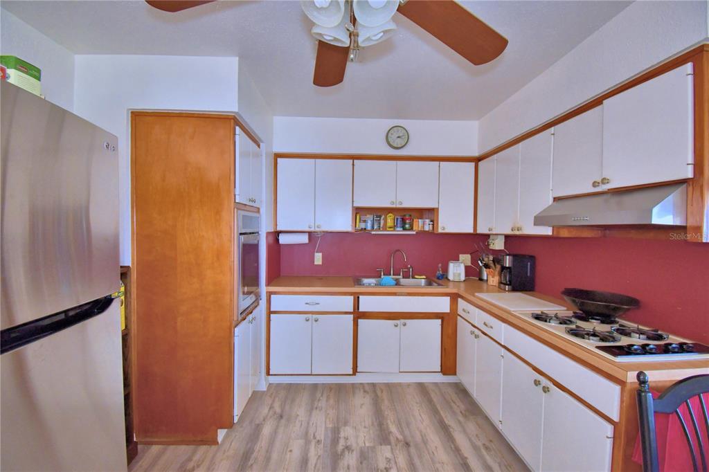 105 Maxcy Lane Frostproof, FL 33843 - Photo 8 of 49 a kitchen with stainless steel appliances a stove a sink and cabinets