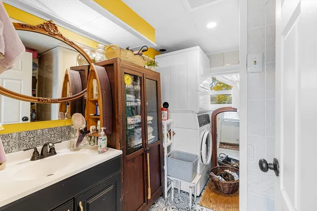 a bathroom with a sink mirror vanity and toilet