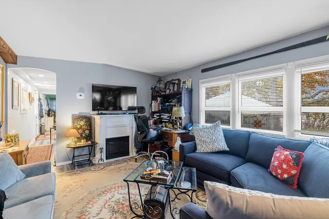 a living room with furniture fireplace and a flat screen tv