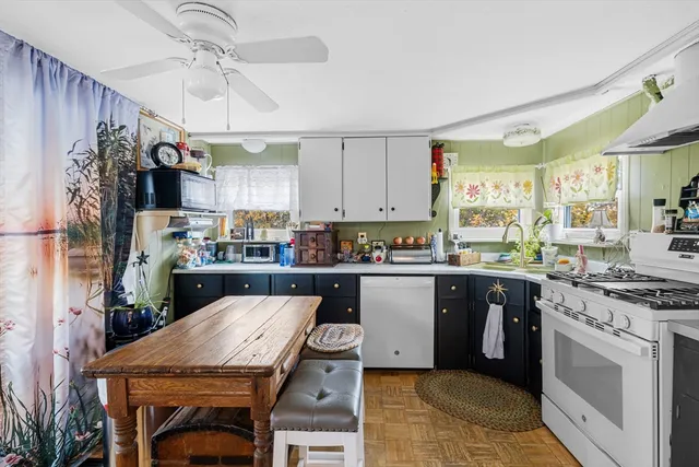 a kitchen with a table chairs stove and cabinets