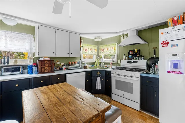 a kitchen with a sink stove and white cabinets