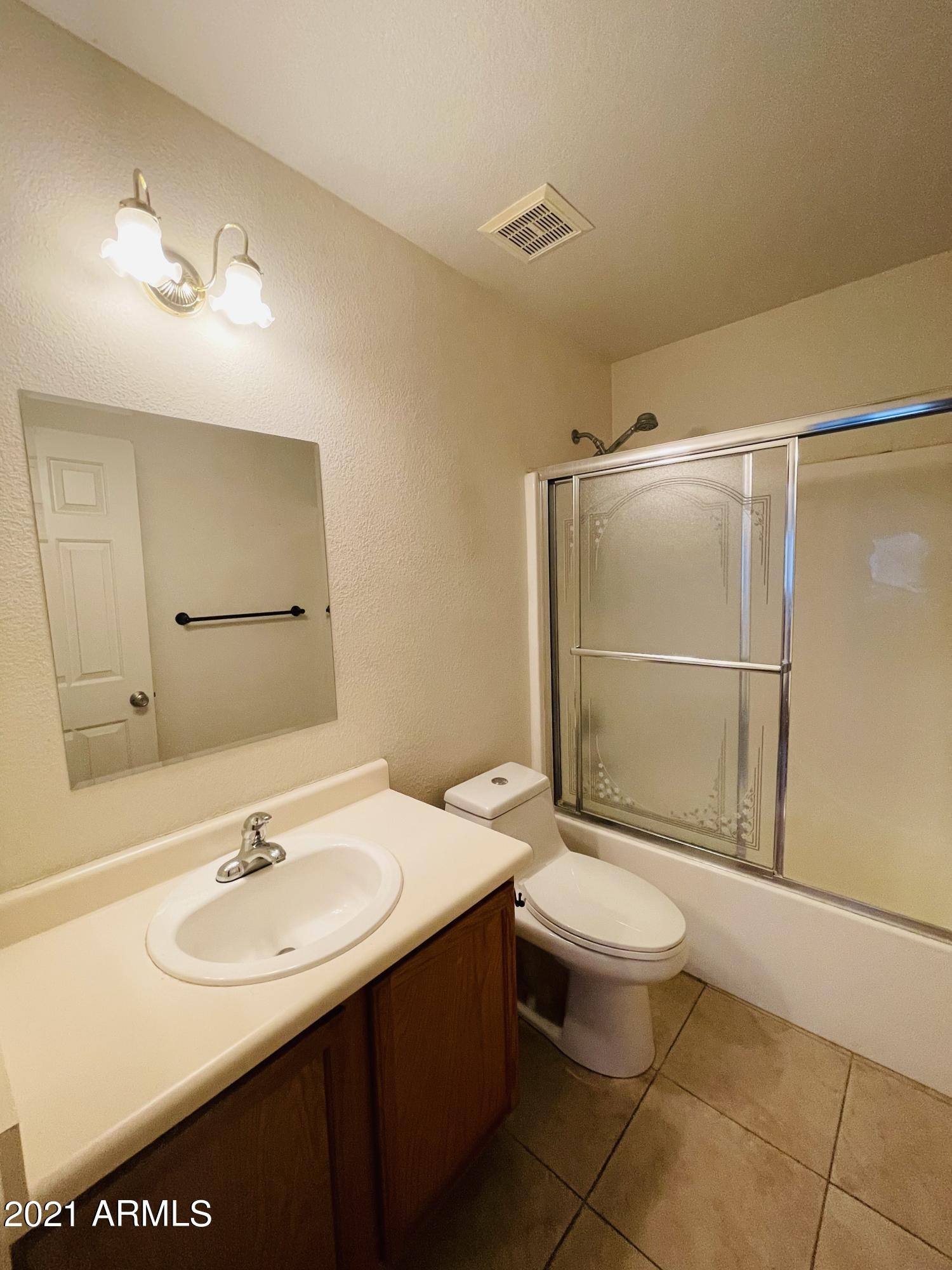 10642 East Arbor Avenue Mesa, AZ 85120 - Photo 11 of 12 a bathroom with a sink toilet and shower