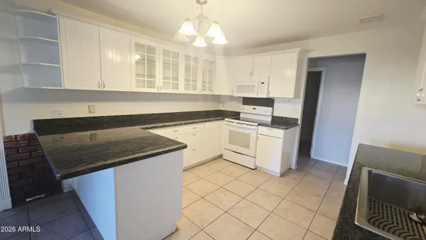 a kitchen with a stove a sink and a refrigerator