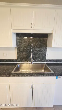 a kitchen with granite countertop a sink and a granite counter tops