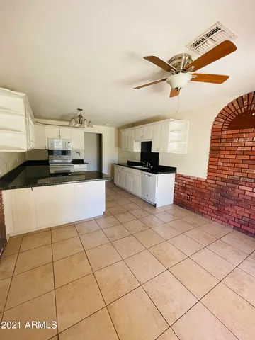 a kitchen with stainless steel appliances a refrigerator sink and cabinets