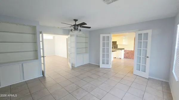 a view of empty room with wooden floor and cabinet